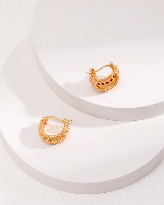 These best-selling hoop earrings feature unique bobble detailing. The chunky gold huggies add a distinctive touch to your style.